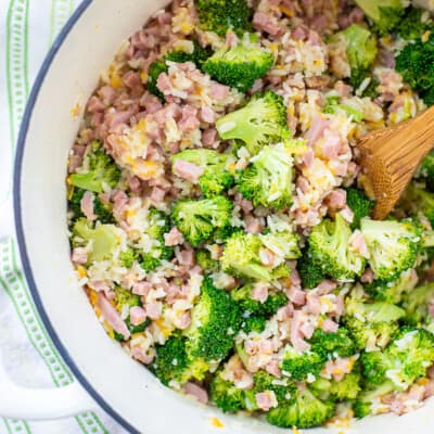 pot full of cheesy rice with broccoli and ham.