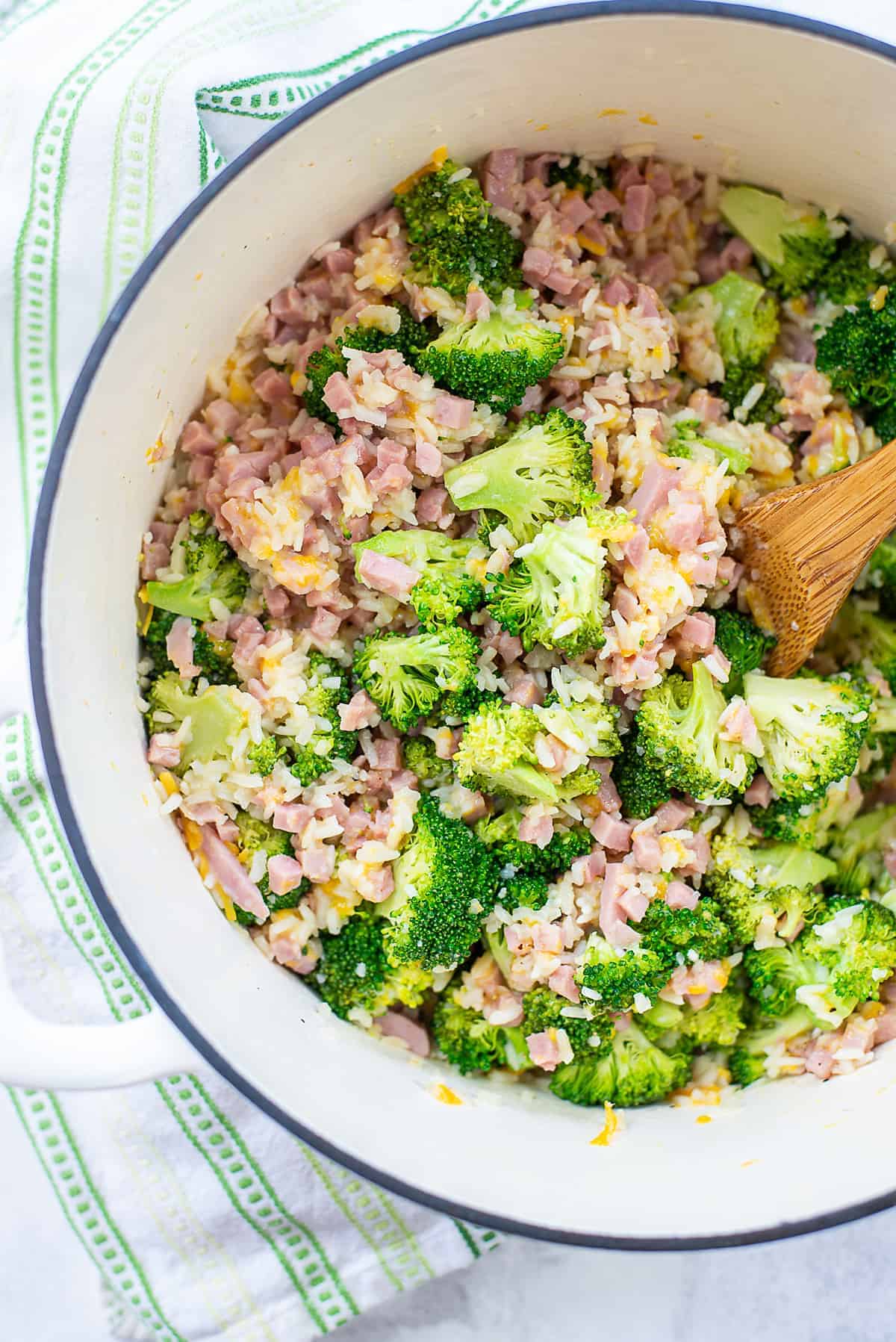 pot full of cheesy rice with broccoli and ham.