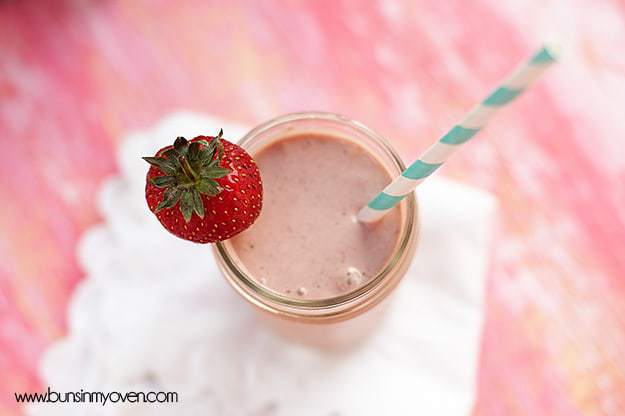 Overhead view of a strawberry milkshake in a glass jar