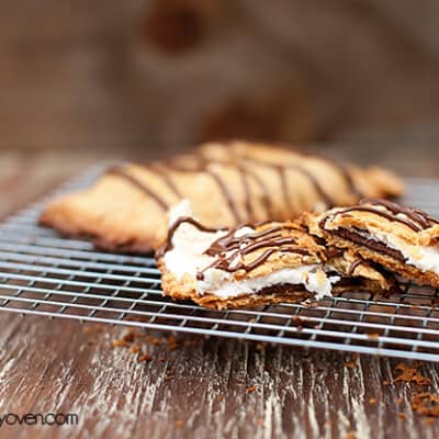 A smores pop tart split in half on a wire cooling rack.