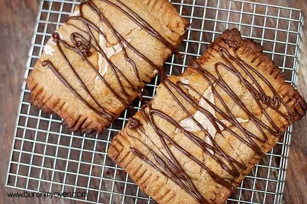 A close up of two pop tarts on a cooling rack.