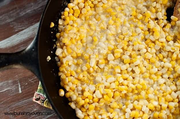 Creamed corn in a cast-iron skillet on a table.