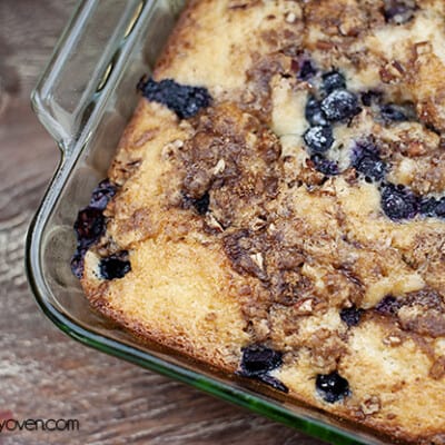A close up of a blueberry honey bun cake in a glass baking pan.