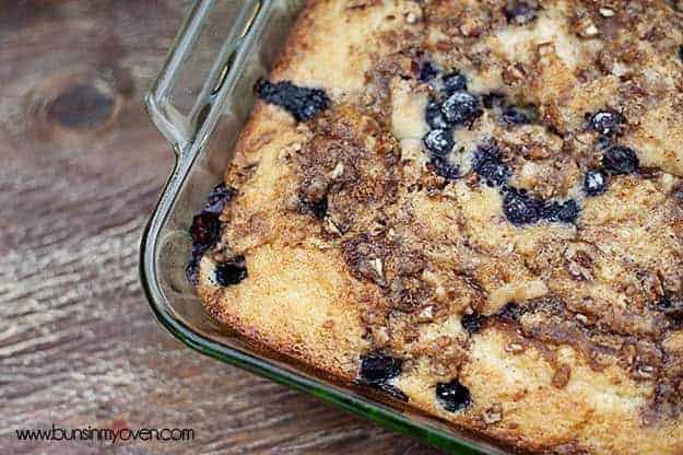 A close up of a blueberry honey bun cake in a glass baking pan.