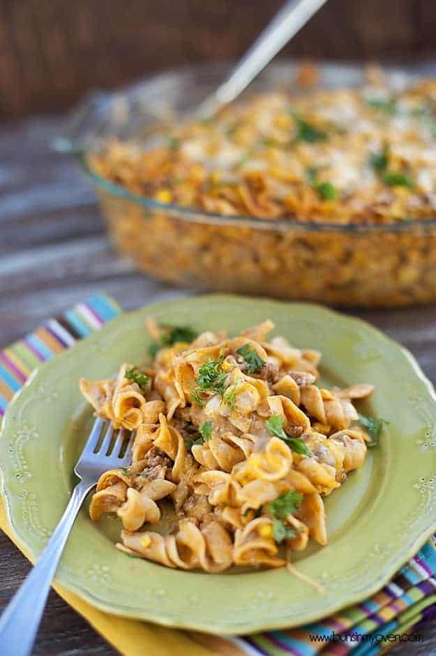 An enchilada casserole with a fork on a plate.