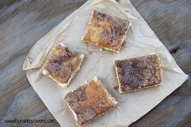 An overhead view of four sopapilla cheesecake bars on a table.