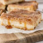 Slice of sopapilla cheesecake with honey drizzled over the top.
