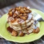 A stack of caramel apple pancakes on a green plate.