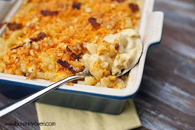 A baking pan of cheetos on top of macaroni and cheese