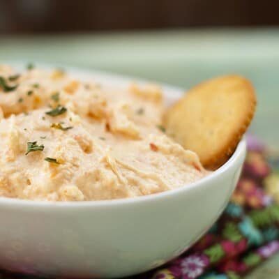 A pimento cheese dip with a ritz cracker in it.
