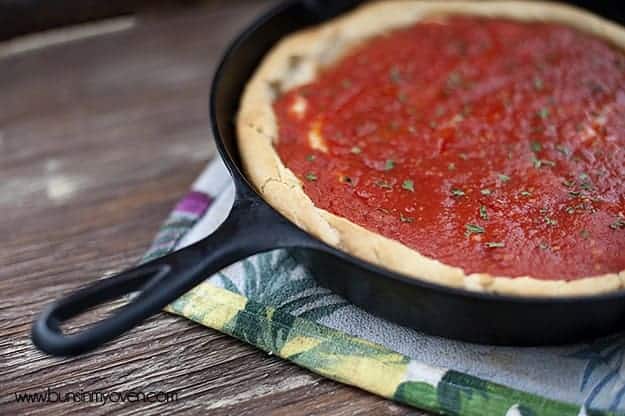 A deep-dish pizza in a cast-iron skillet.