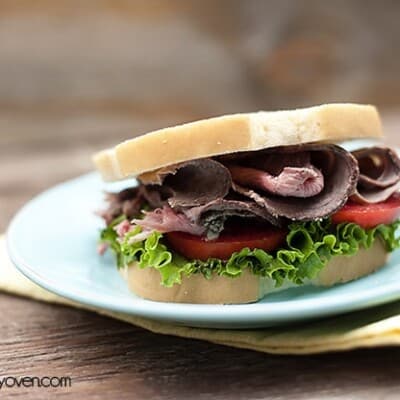 A roast beef sandwich on a white plate