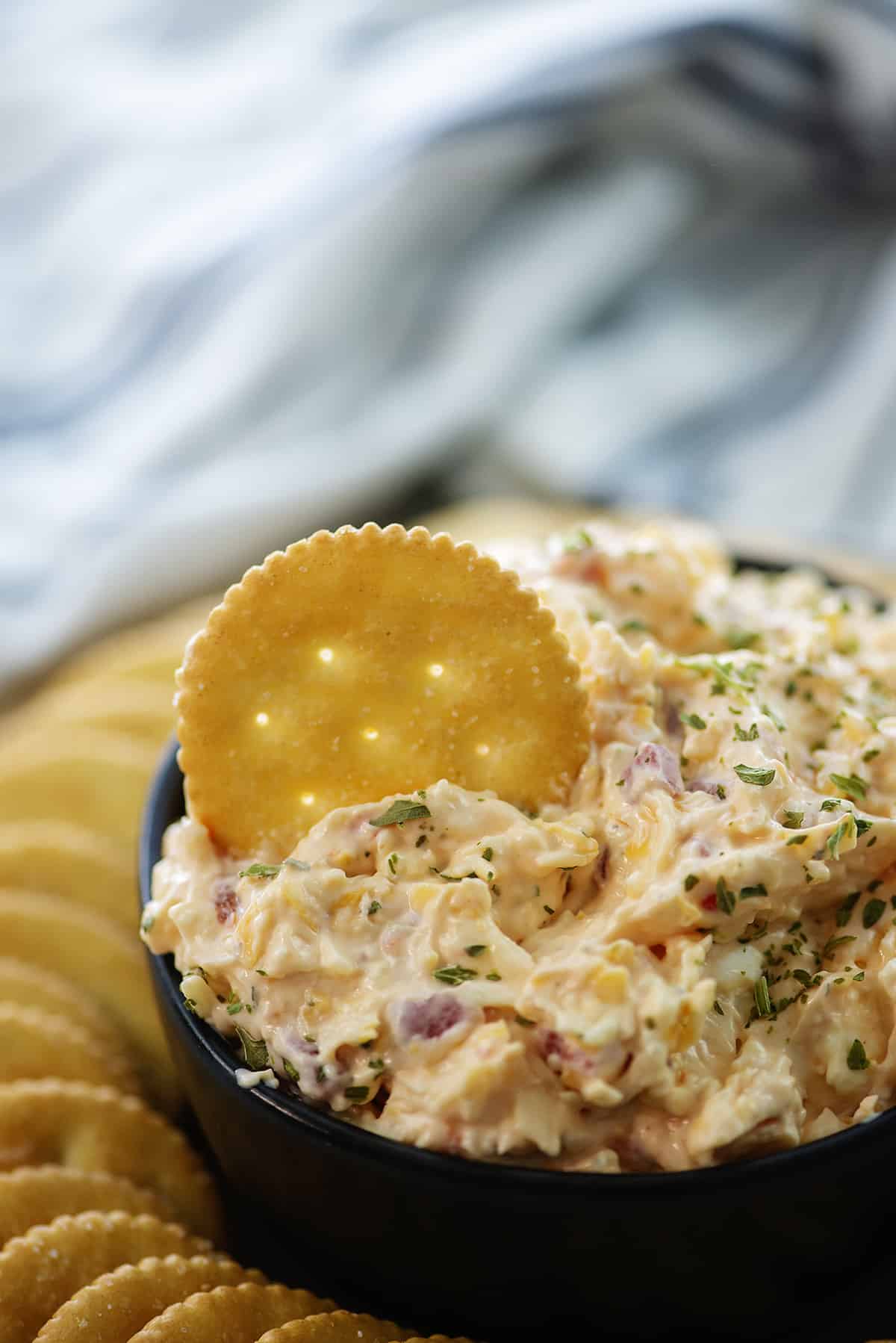 creamy pimento cheese recipe in a bowl with crackers.