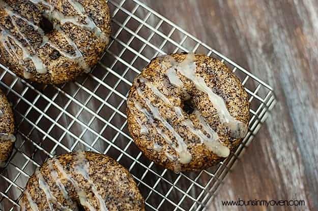 A close up of a white chocolate mocha donut on a wire cooling rack