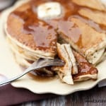 A fork stabbing through a bite of pancakes.