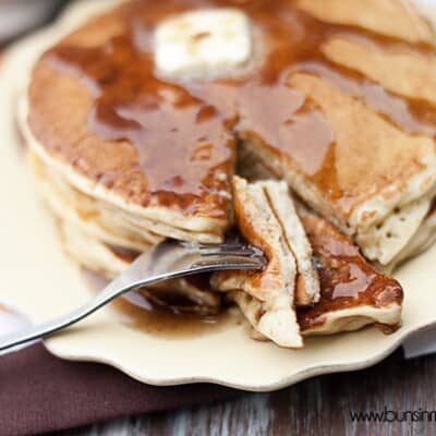 A fork stabbing through a bite of pancakes.