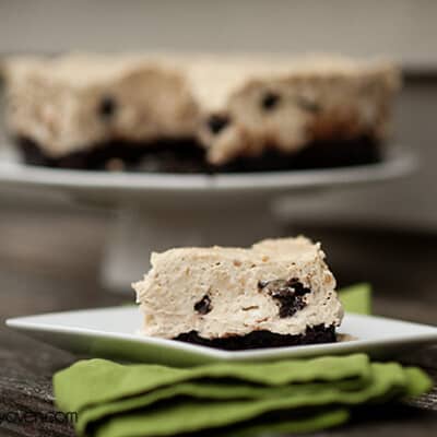 A brownie cheesecake square on a folded cloth napkin