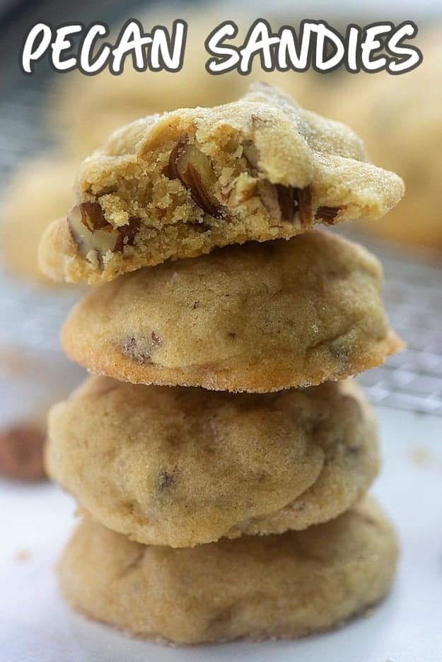 A stack of cookies with a bite taken out of the top one.