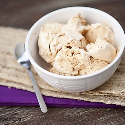 A white bowl with a few scoops of pumpkin ice cream in it.