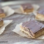 A chocolate peanut butter cookie bar on a wooden table.