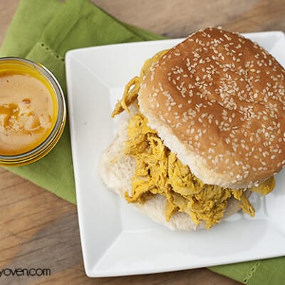 Overhead view of a sandwich sitting on a square white plate.