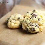 A close up of a couple gooey butter cookies on parchment paper.