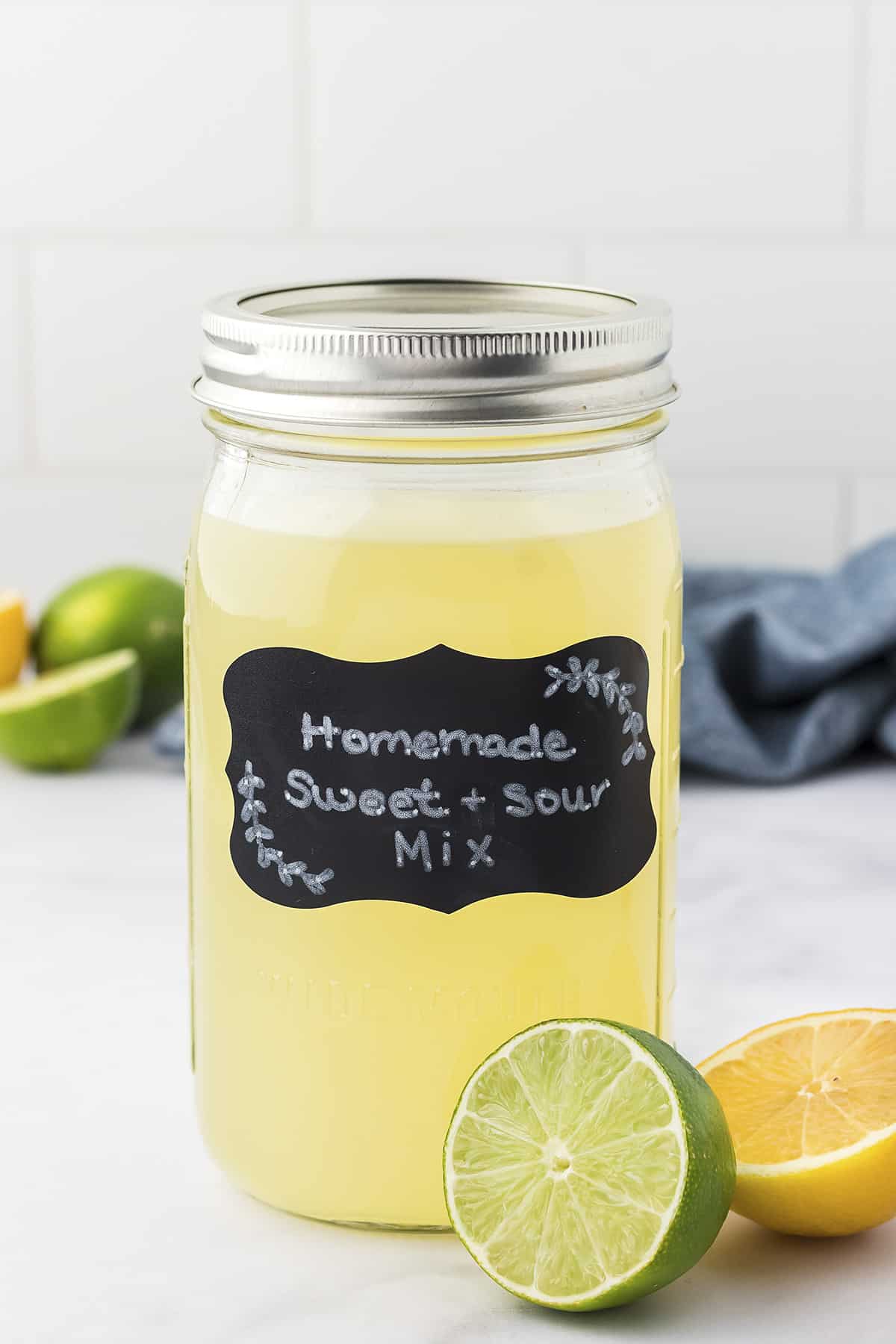 Homemade sour mix in mason jar with label.