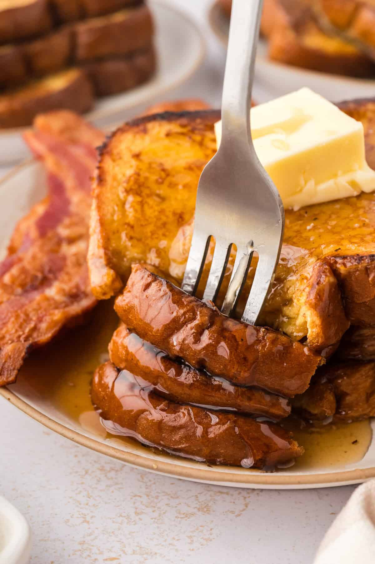 Fork in stack of eggnog french toast.