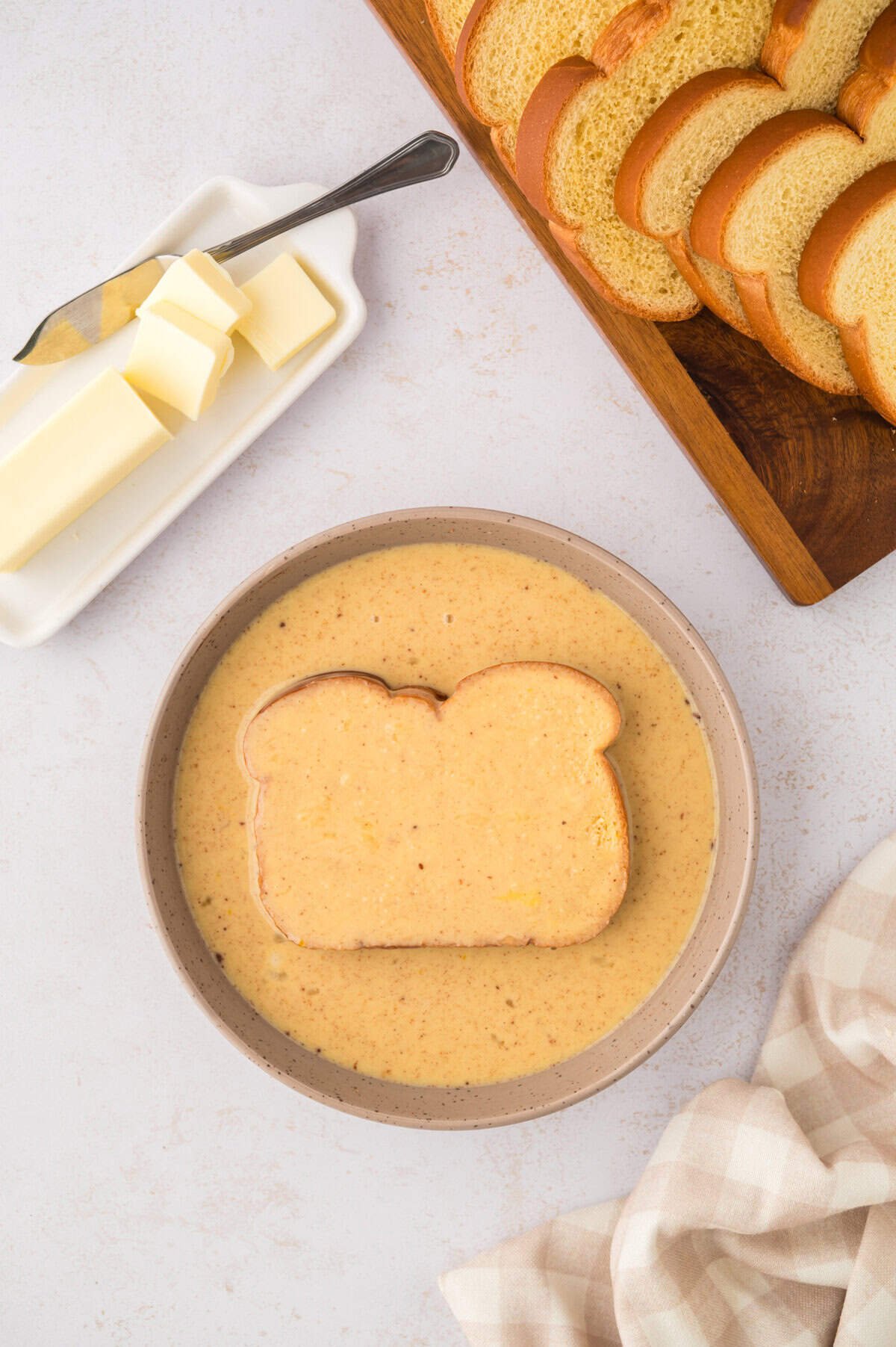 Bread soaking in custard.