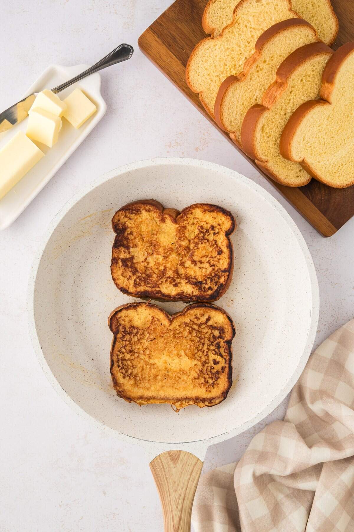 Eggnog french toast cooking on a skillet.