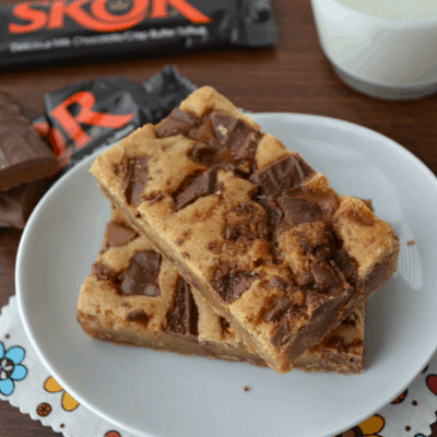 A plate with two toffee blondies on it.