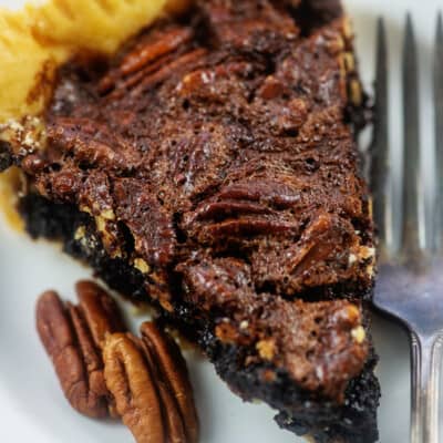 pecan pie on white plate.