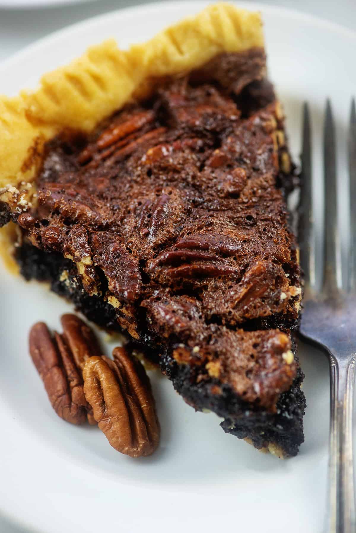 pecan pie on white plate.