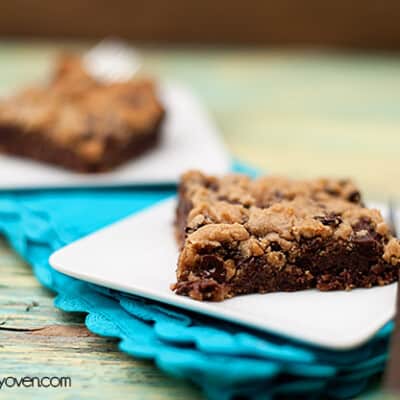 A chocolate chip cookie bar on a folded blue napkin.