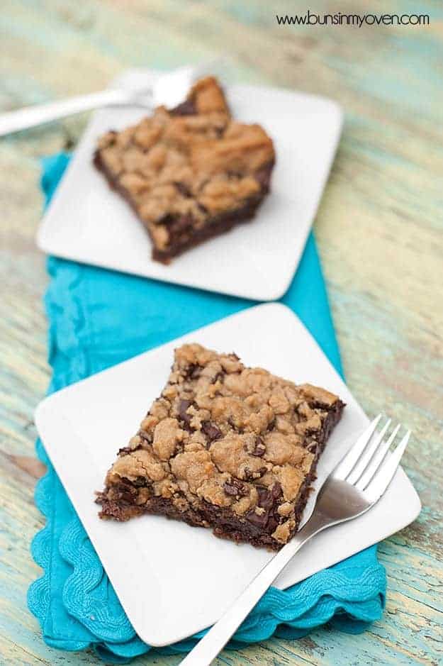 Two toffee cookie bars on separate white plates.