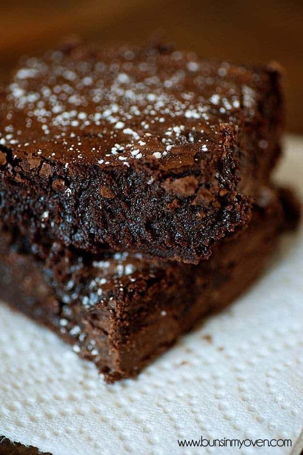 Two Nutella brownies stacked on a paper towel.