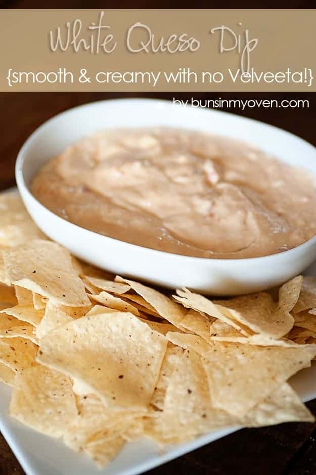 creamy queso dip in a white bowl next to a bunch of chips.