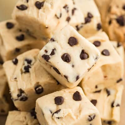 A close up view of a stack of pieces of chocolate chip cookie dough fudge.