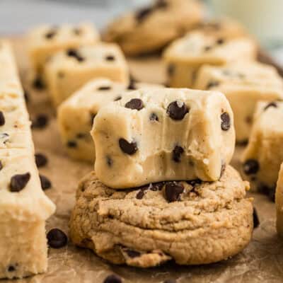 Cookie dough fudge stacked on top of a chocolate chip cookie.