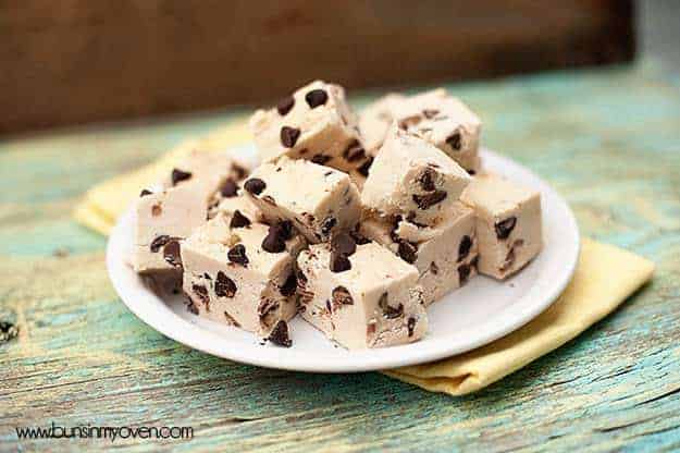 Small pieces chocolate chip fudge piled on a plate.