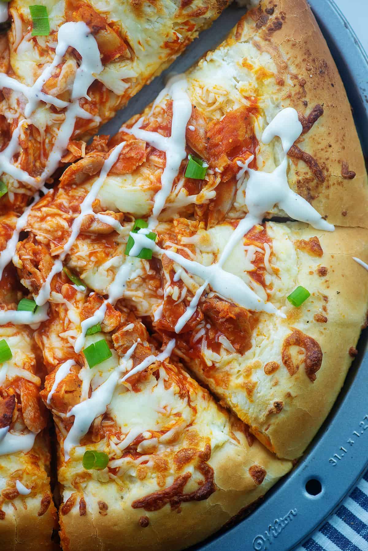 overhead view of sliced buffalo chicken pizza.