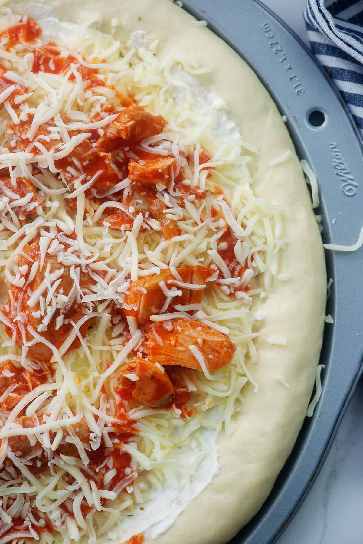 buffalo chicken and mozzarella on pizza dough.