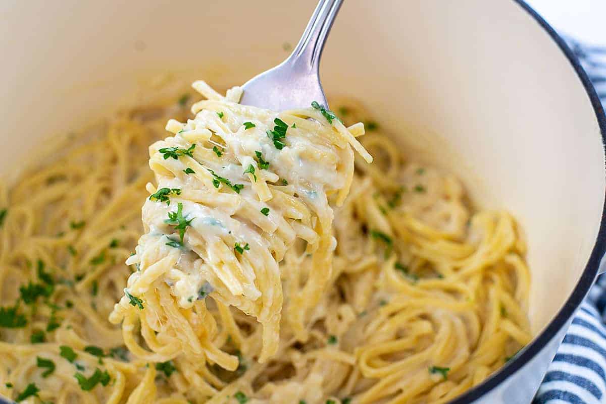 pasta on fork over pot.