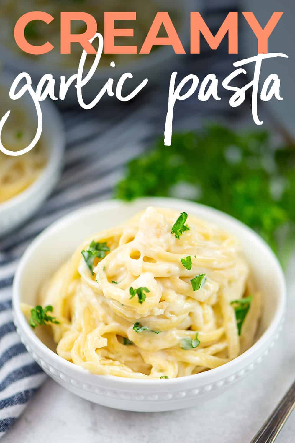 creamy garlic pasta in white bowl.