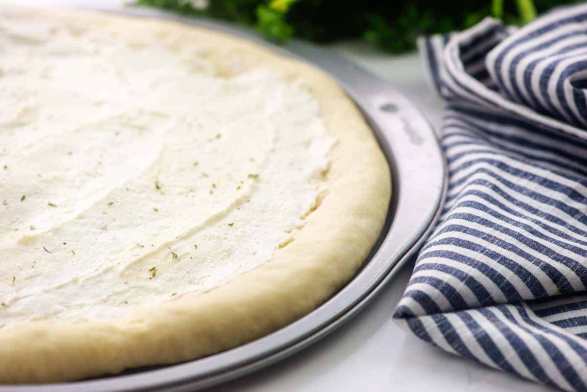 cream cheese mixture on pizza dough.