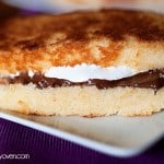 A close up of a pound cake smores sandwich on a plate.