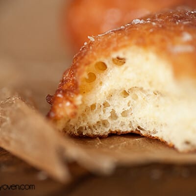 A close up of a bite taken out of a donut.