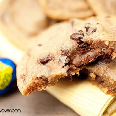 A half eaten cadburry stuffed cookie.