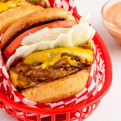 double double animal style burger in red basket.