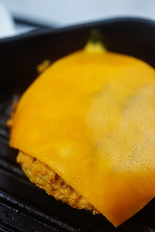 chicken burger with cheddar slice on grill pan